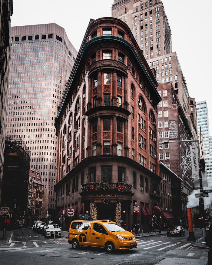 Classic New York street scene featuring historic architecture and iconic yellow taxi.